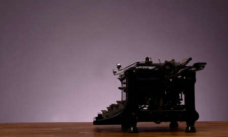 Old vintage typewriter on a wooden table with space for text or imageの写真素材