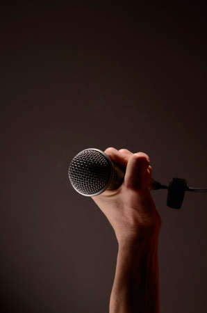 Male hand with a microphoneの写真素材