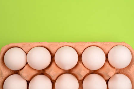Fresh white eggs on a green backgroundの写真素材