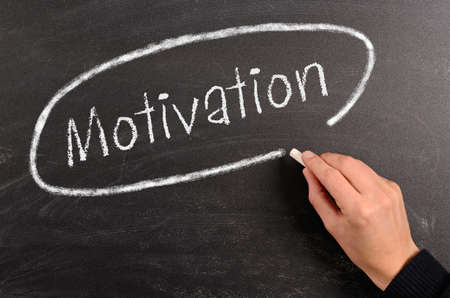 Hand writing Motivation with chalk on a blackboardの写真素材