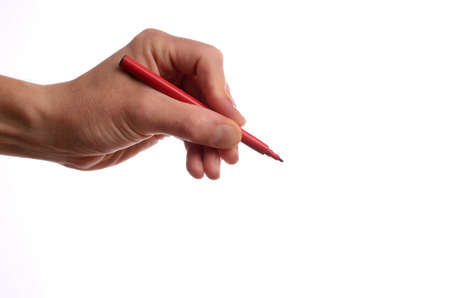 Hand with a red pen on a white backgroundの写真素材