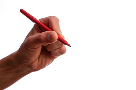 Hand holding a red pen on a white backgroundの写真素材