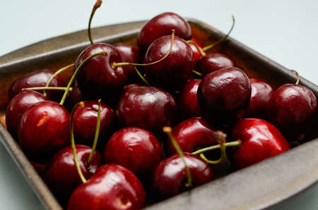 Close up of fresh cherries in a ceramic bowlの写真素材