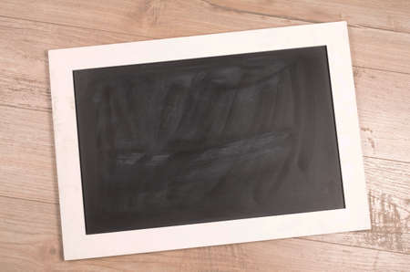 Chalkboard on a rustic wooden backgroundの写真素材