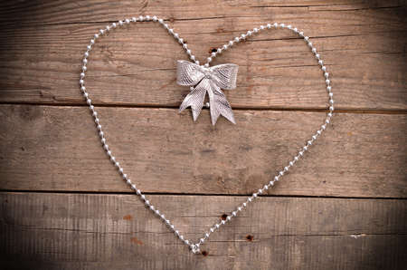 Heart shape of pearls on a wooden backgroundの写真素材