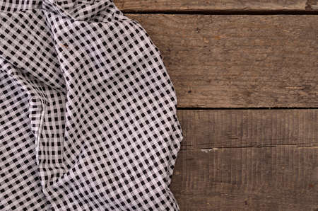 Checkered table cloth on a wooden backgroundの写真素材