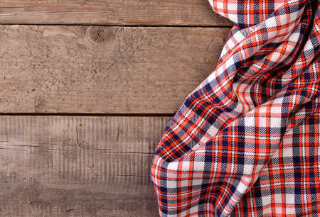 Checkered table cloth on an old wooden tableの写真素材