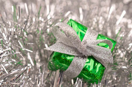 Green Christmas present with silver decoration, shiny Christmas backgroundの写真素材
