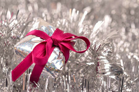 Christmas present with a pink bow and silver decorationの写真素材