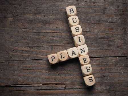 Wooden dices with the words business and plan