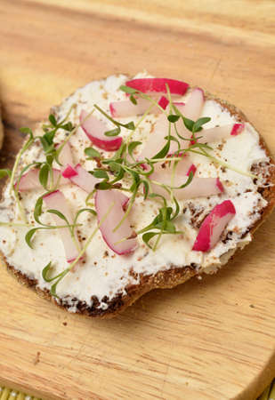 Whole grain rolls with curd and radish and fresh cressの写真素材