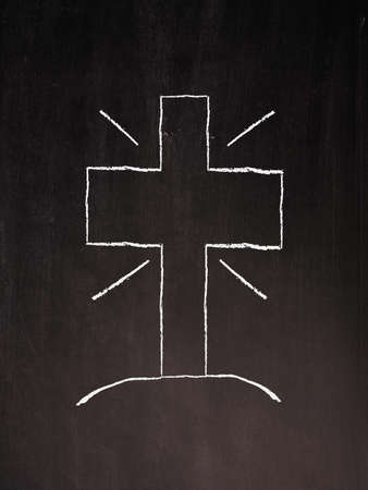 Silhouette of a cross on a chalkboardの写真素材