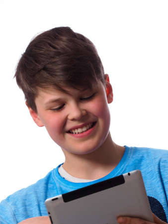 Young boy using a tablet computer on a white backgroundの写真素材