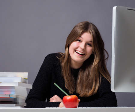 Young woman in an office working on a computerの写真素材