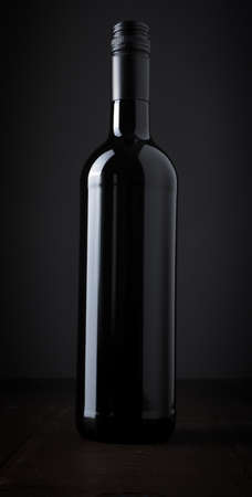 Bottle of wine on an old wooden oak plankの写真素材