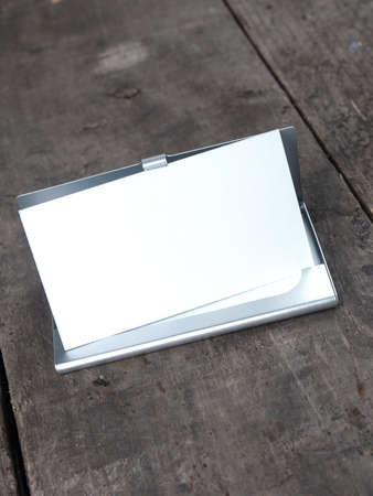 Close up shot of a business card on a rustic wooden office tableの写真素材