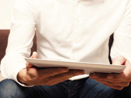 Close up shot of an businessman with a tablet computer, selective focus on foregroundの写真素材