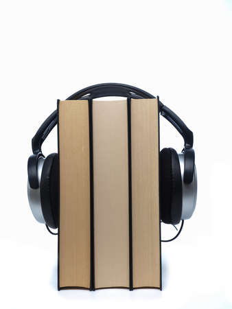 Books with headphones on a white background
