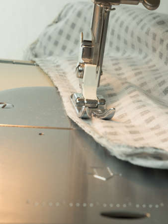 Close up shot of sewing a checkered fabric