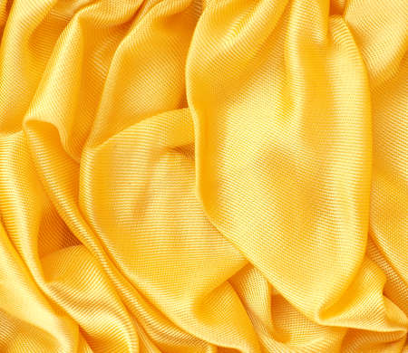Golden satin fabric texture using as background with space for text or imageの写真素材