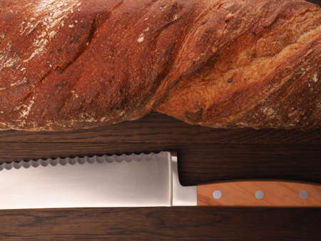 Closeup of an organic baguette bread on a wooden table