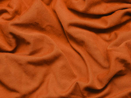Orange fabric texture using as background with space for text