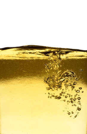 Background of pouring oil on a white background with space for textの写真素材