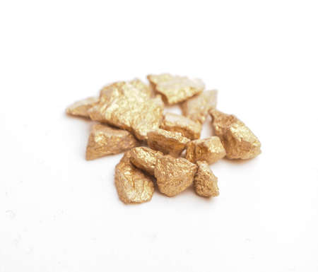 Close up of golden nuggets on a white backgroundの写真素材