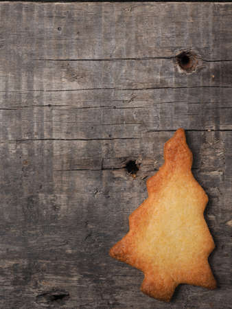 Christmas tree shaped cookie on a rustic wooden background