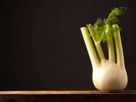 Organic fennel on an old rustic wooden table with space for textの写真素材