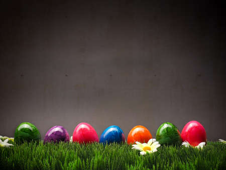 Colorful Easter eggs in a row on grass