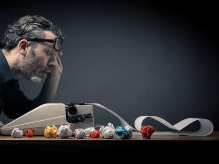 Editaor with his old typewritar at work in his officeの写真素材