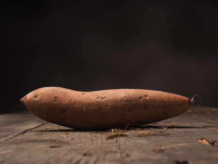 Fresh batata on an old rustic wooden tableの写真素材