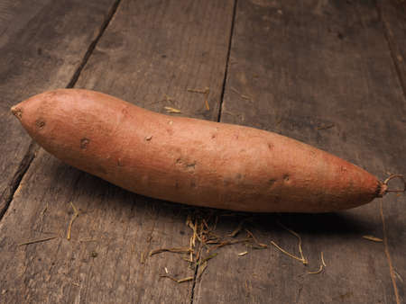 Fresh batata on an old rustic wooden tableの写真素材