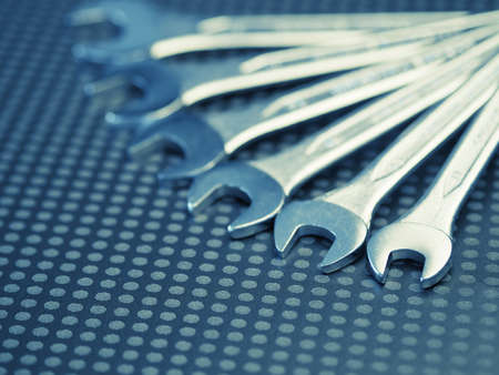Chrome wrench assortment on a modern dark background with space for text, selective focus