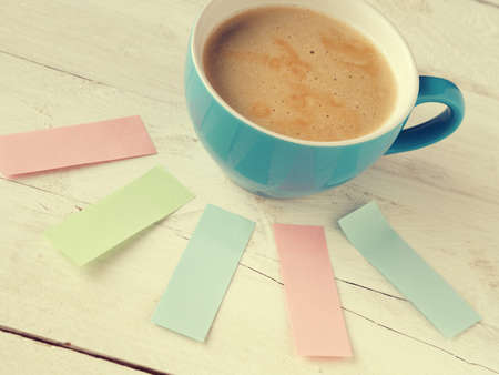 Blue cup of coffee with colorful sticky notes, many ideas conceptの写真素材