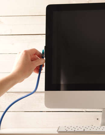 Male hand with stethoscope checking an older computerの写真素材