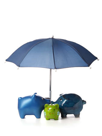 Protect your savings, Three piggy bank with an umbrella on a white backgroundの写真素材
