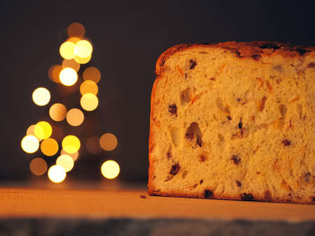 Half of a Panettone with a Christmas tree in backgroundの写真素材