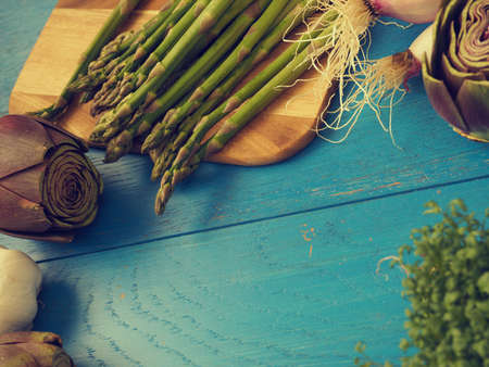 Healthy food concept with organic vegetables on a rustic wooden table, natural light with selective focus, vintage color tonedの写真素材
