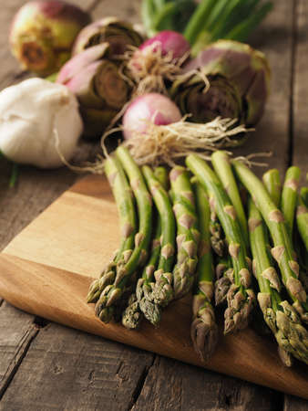 Healthy food concept with organic vegetables on a rustic wooden table, natural light with selective focusの写真素材
