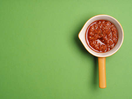 Red pesto on green backgroundの写真素材