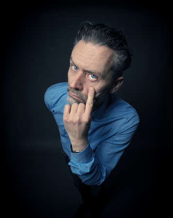 Crazy business man on a dark backgroundの写真素材