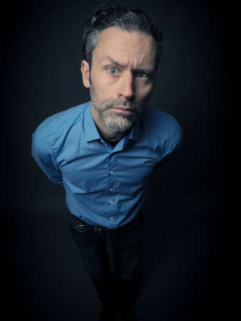 Crazy business man on a dark backgroundの写真素材