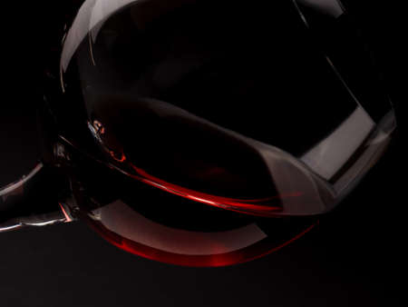 Glass of red wine on a dark background