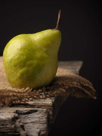 Fresh organic pear on an old wooden kitchen tableの写真素材