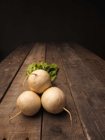 May turnip on a rustic wooden table with space for textの写真素材
