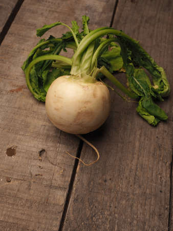 May turnip on a rustic wooden table with space for textの写真素材
