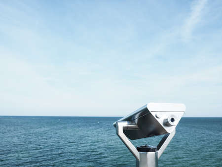 Binoculars on a sea bridge, Baltic sea on a summer day, space for text on left sideの写真素材