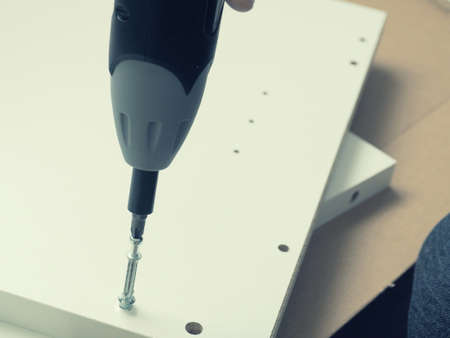 Close up of a screwdriver with screw, assembling furniture conceptの写真素材